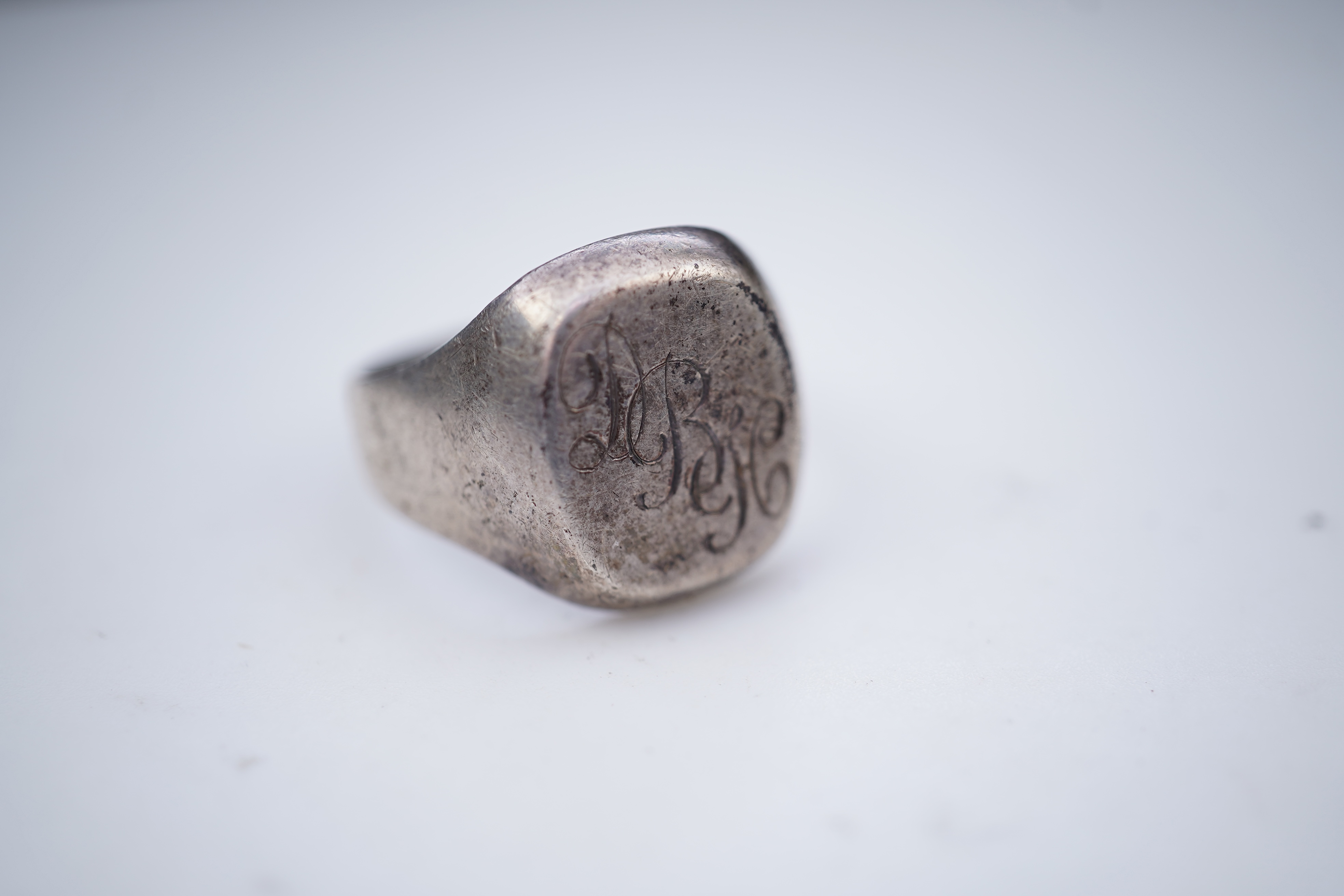 A collection of silver jewels, comprising: a bangle; a chain necklace suspending two winding toothpicks, one with toothpick deficient; a rope twist chain; a pair of cufflinks with the initials DBH; a pendant of abstract